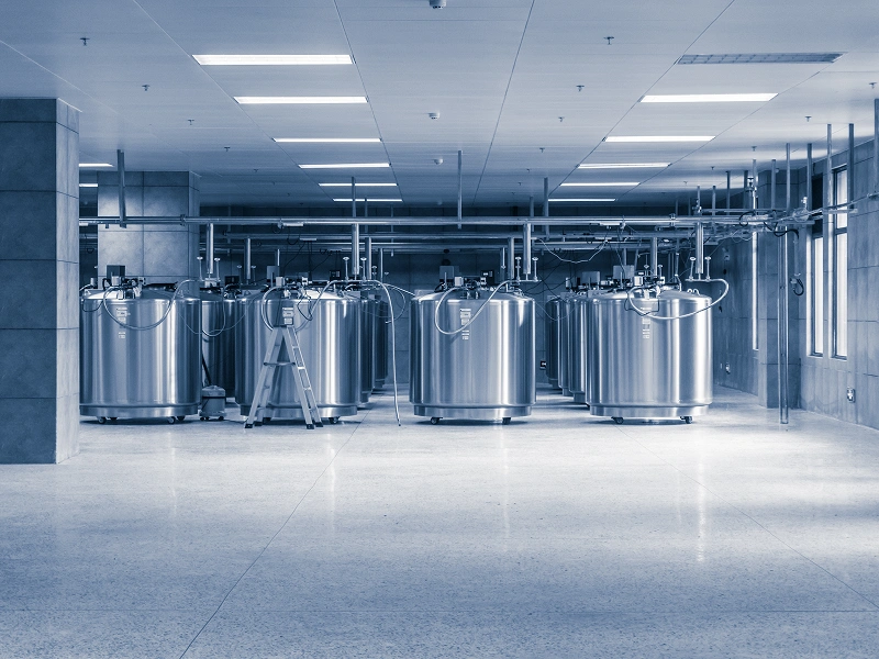 Industrial tanks in a sterile laboratory setting.